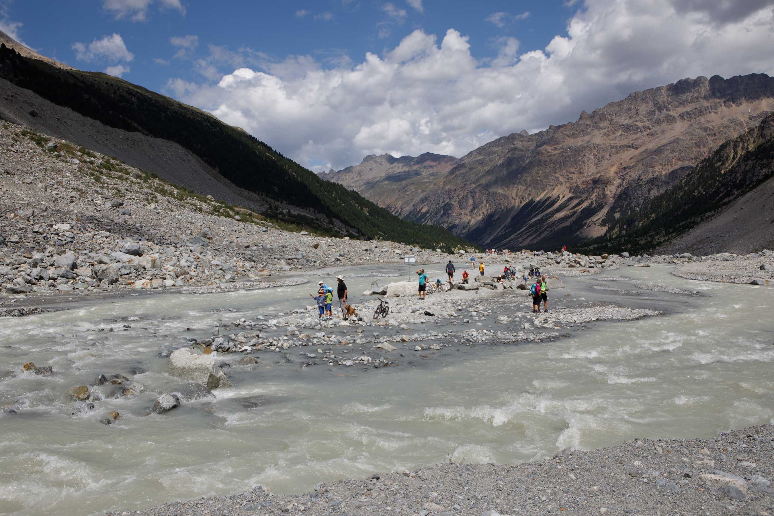 Tourists in the melt water of the Morteratsch Glacier